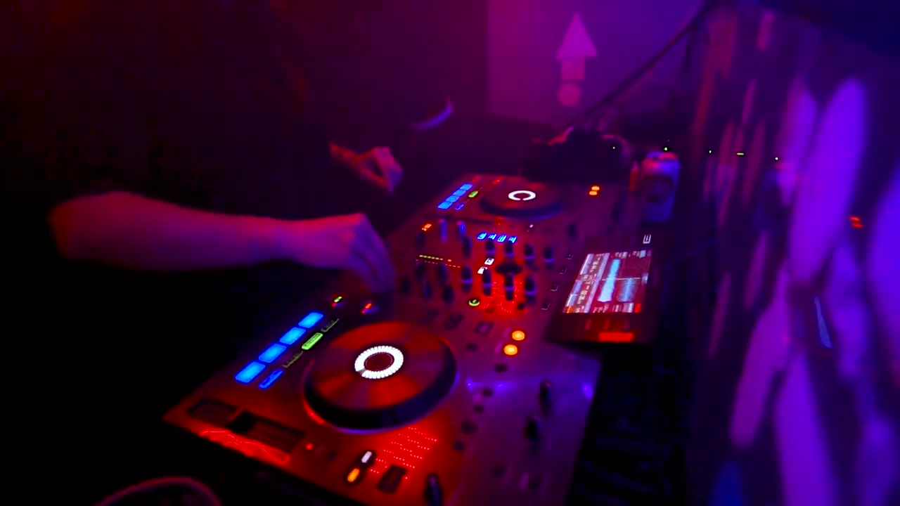 A DJ controller and turntables set up to rent for a party.